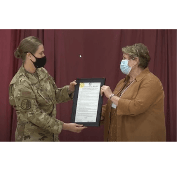 Supervisor Hoek presents Colonel Fox with a certificate of appreciation