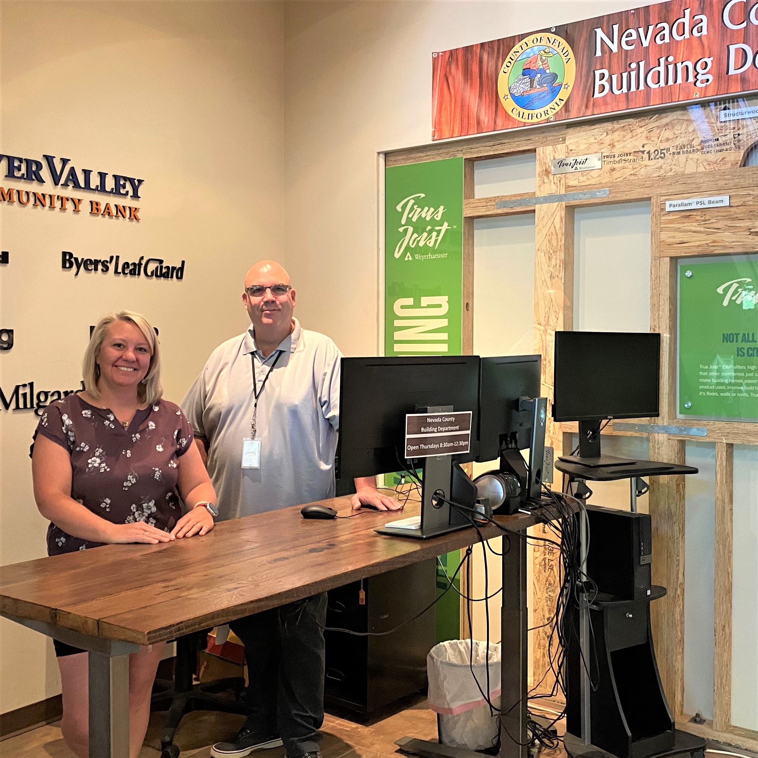 NCCA and Nevada County Staff standing at Building Outpost Desk at NCCA.