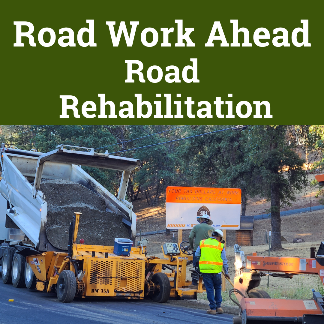 Road Rehabilitation Project - Truck and two staff working on spreading mix SB1 Sign in Background