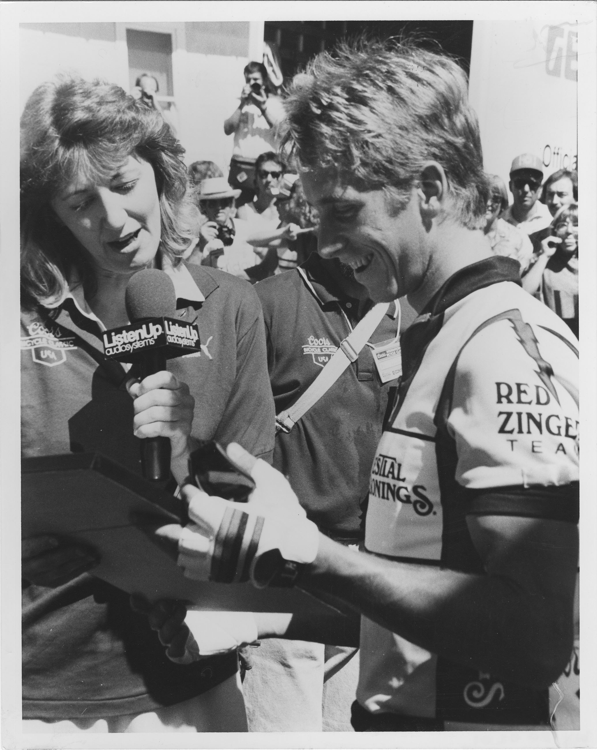 bicycle racer speaks to a reporter holding a microphone