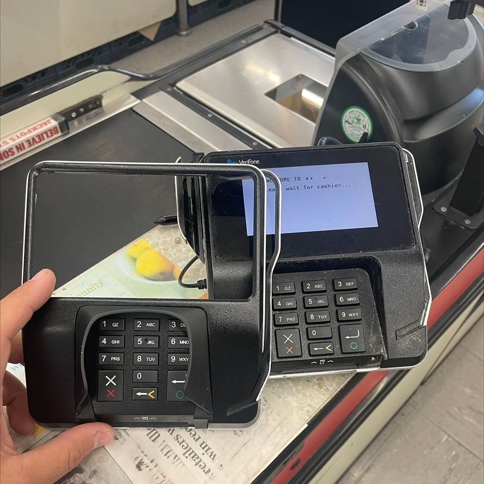 Image of a skimming device next to a stores card reader 