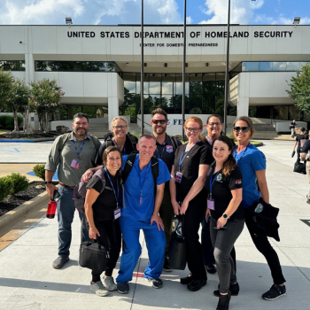 Photo of staff in front of the US Department of Homeland Security center for emergency preparedness 