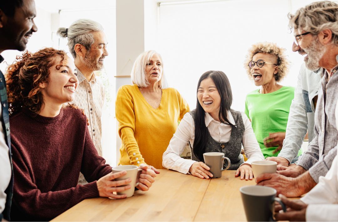 A group of people smiling around a table
