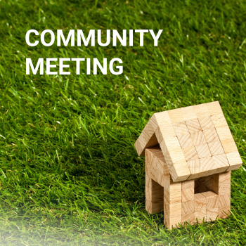 Community Meeting, next to house made of blocks 