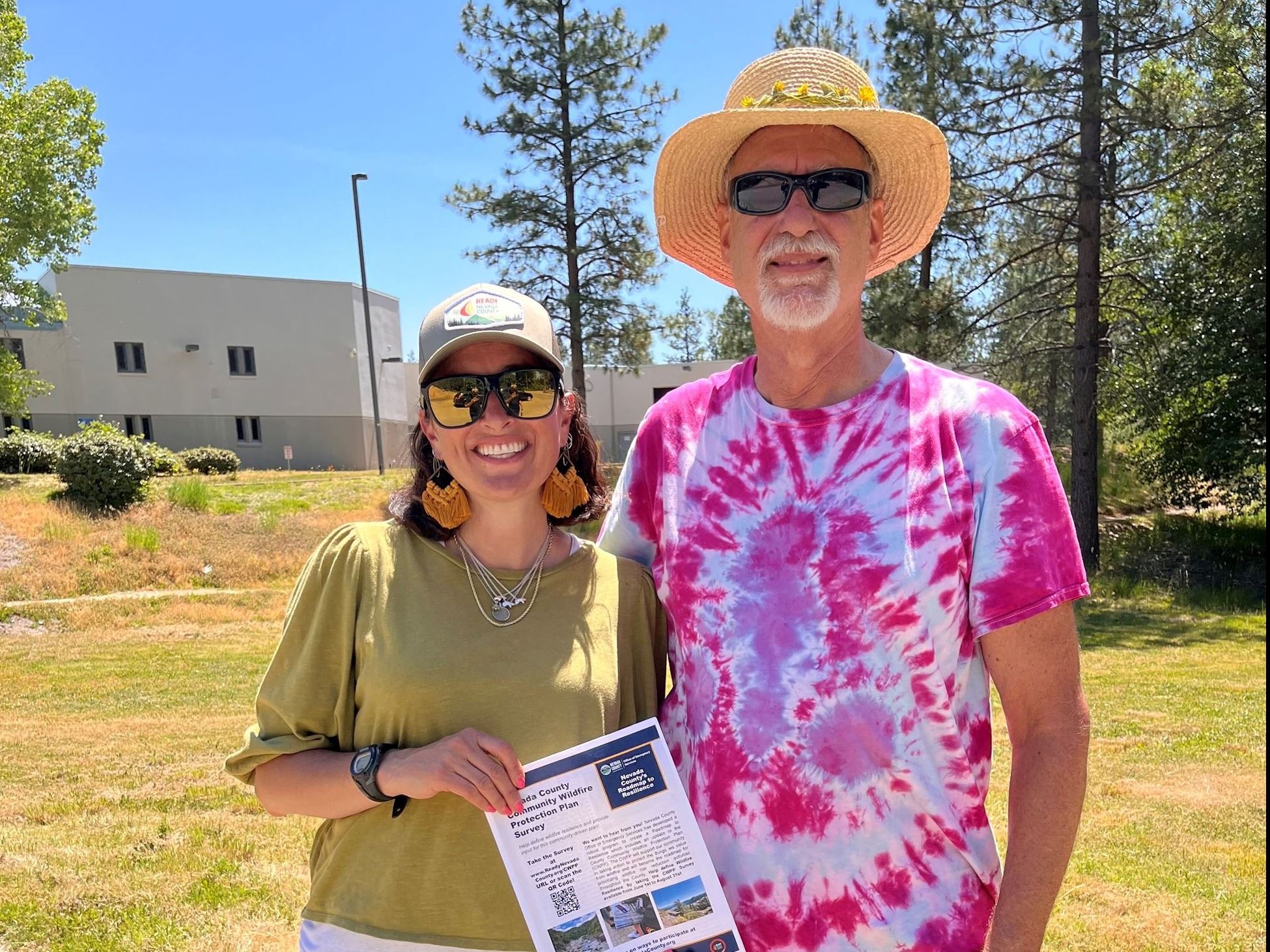 Nevada City Green Waste Alex Keeble-Toll stands next to Nevada County Resident in field 