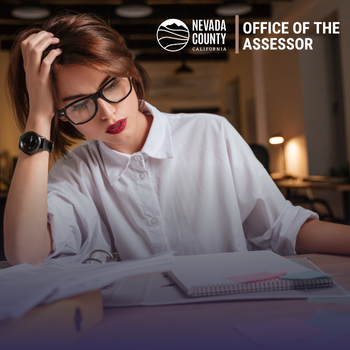 A photo of a person at a desk with paperwork.