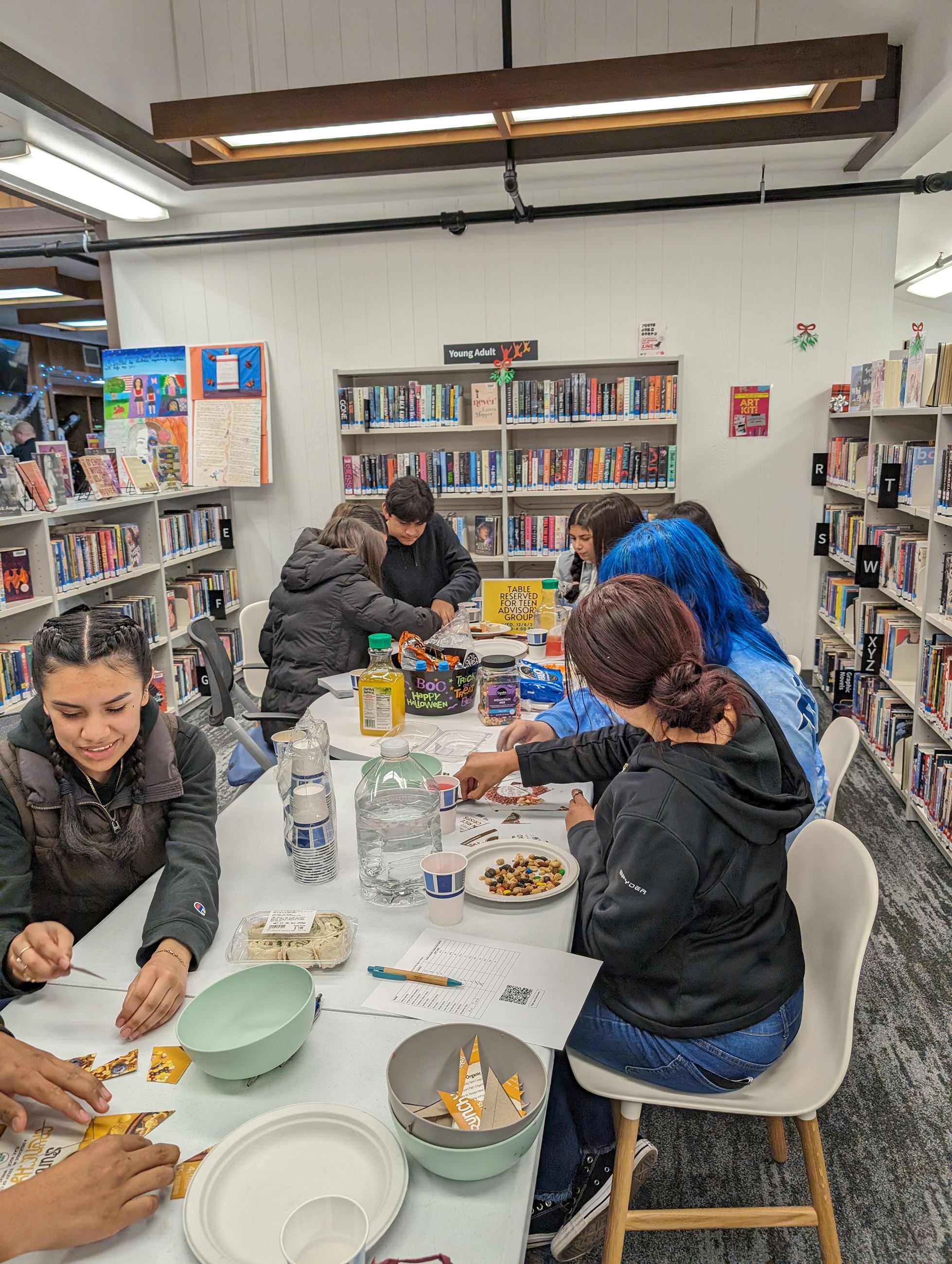 Group of teens putting together a puzzle.