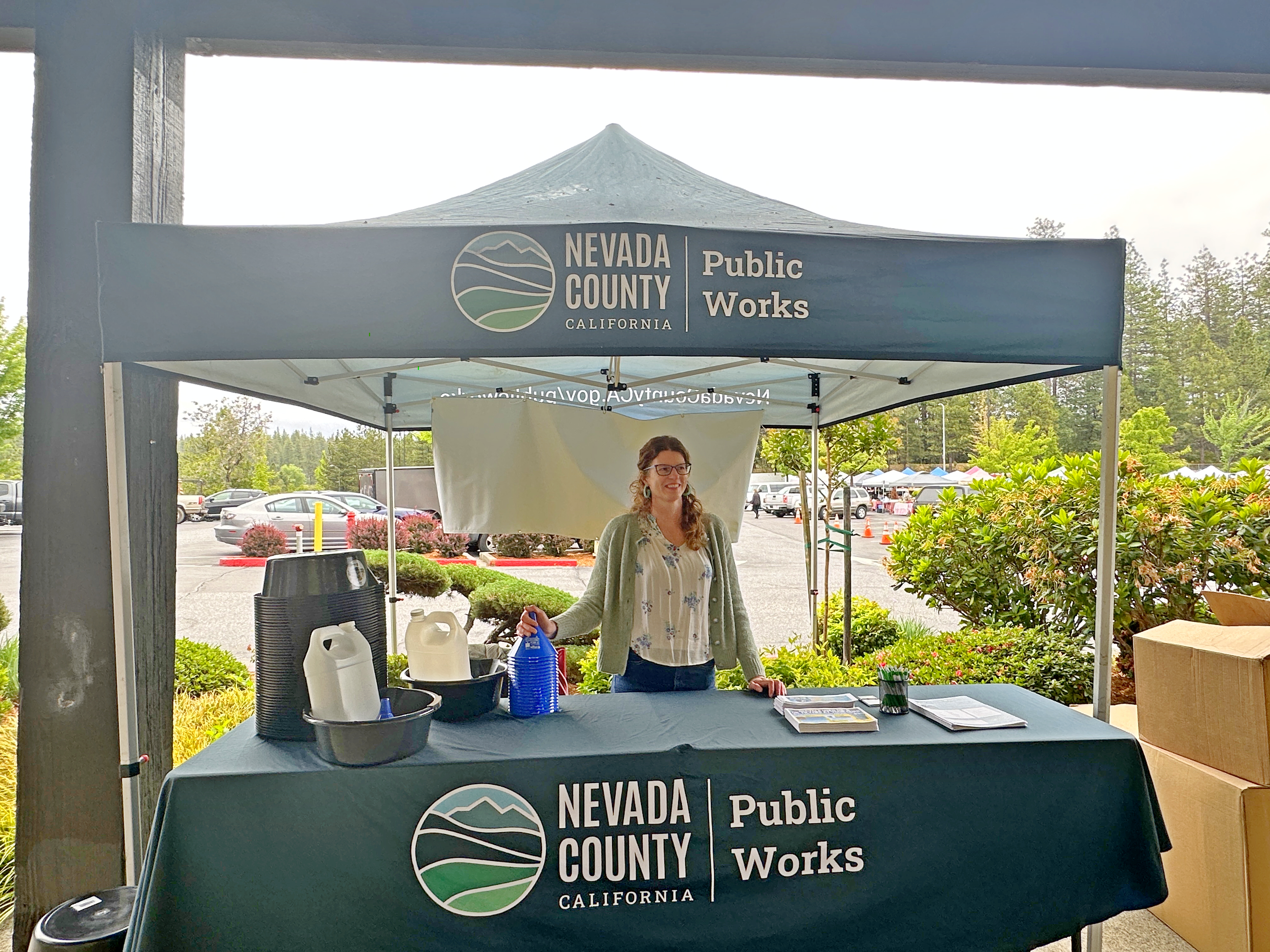 Photo of county staff handing out oil filter change kits and vouchers for oil filters