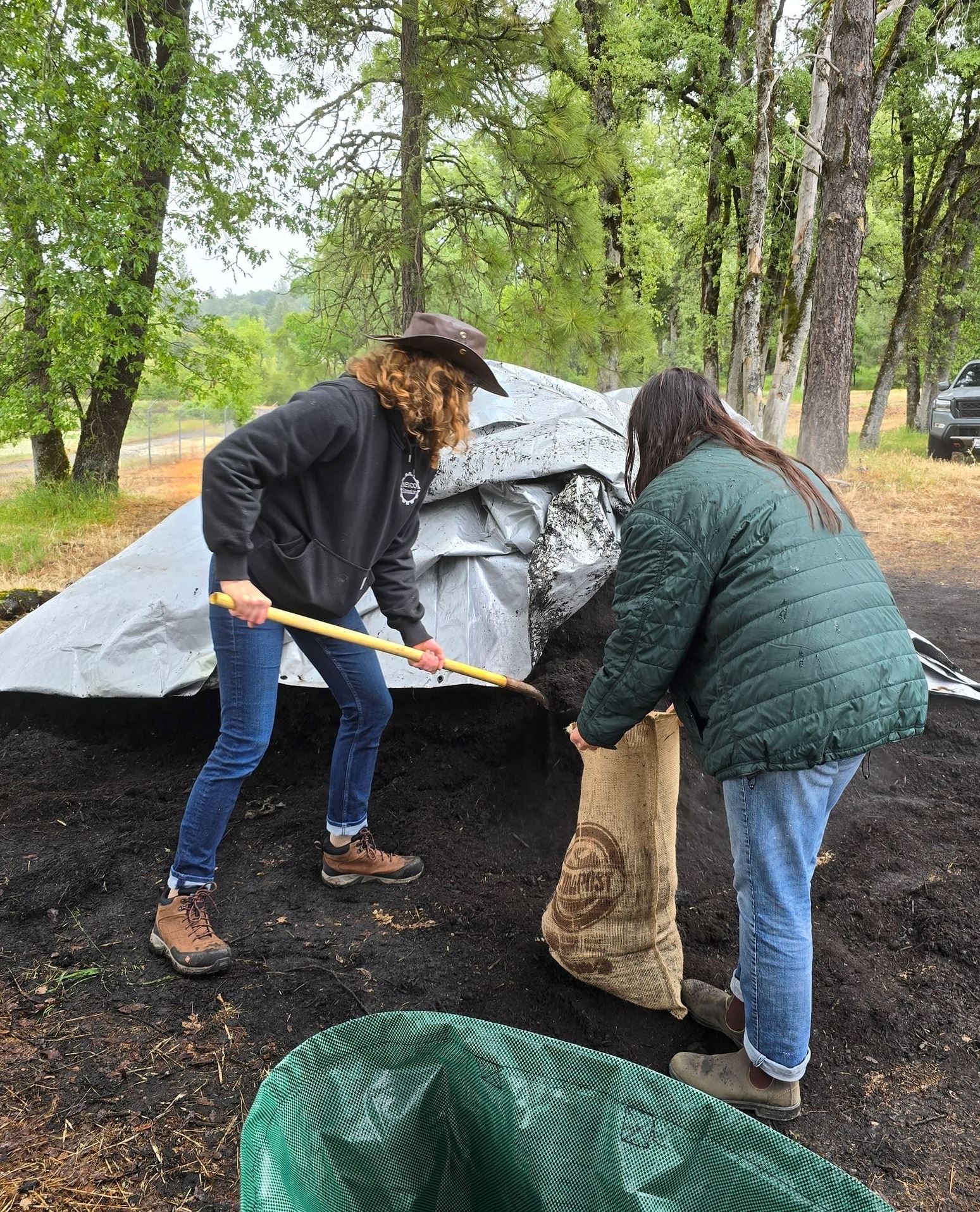 Photo of shoveling compost into burlap sack during April's compost giveaway event