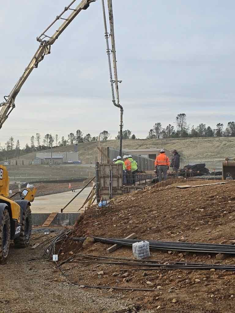 Pouring concrete into wall forms. 